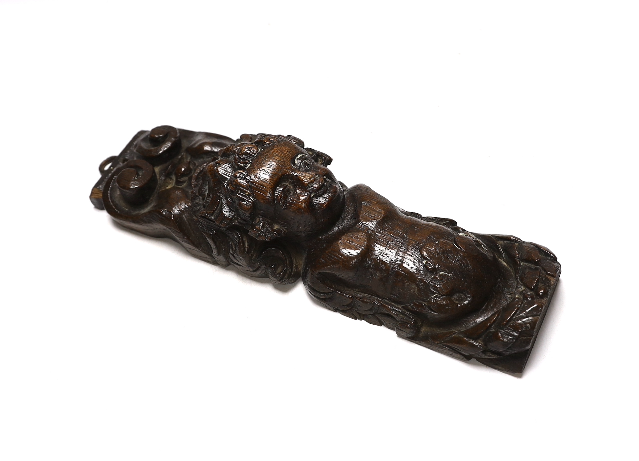 Three 17th century carved oak figural corbels together with corbel end in the form of a lion, largest 30cm high